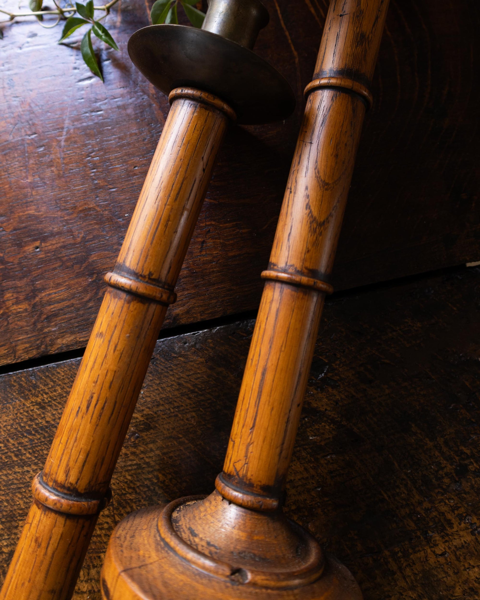 Wooden candlesticks on a dark wooden surface
