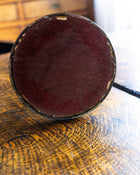 Round dark base of candlestick on a textured surface