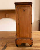 Wooden cabinet on a wooden surface with a blurred background