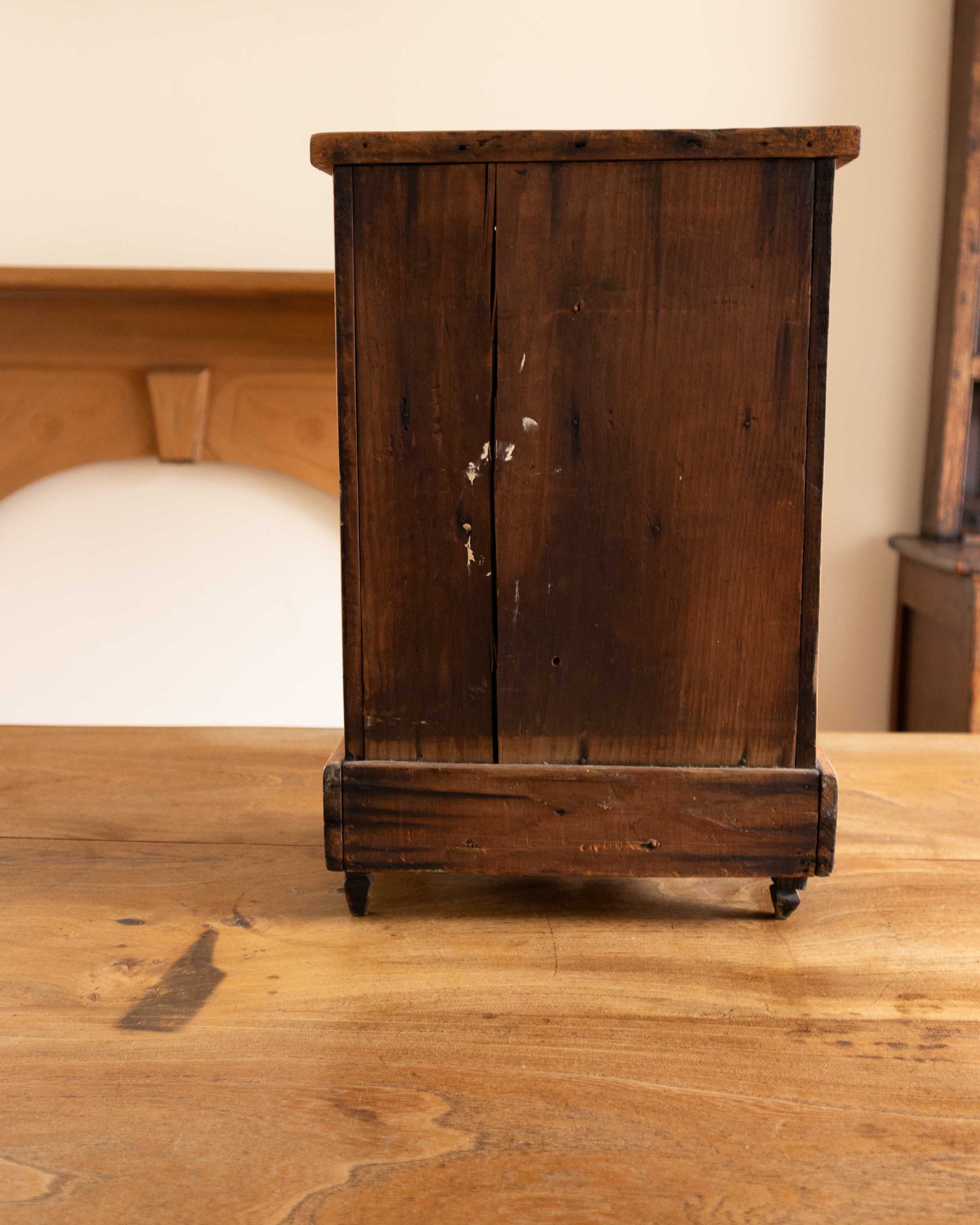 Vintage wooden cabinet on a wooden surface with a blurred background