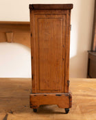 Wooden cabinet on feet with a rustic design in a room setting