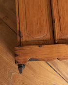 Close-up of a wooden cabinet with visible grain and texture.