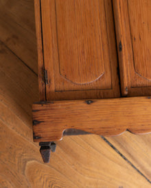 Close-up of a wooden cabinet with visible grain and texture.