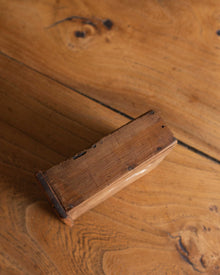 Close-up of a wooden drawer on a wooden surface