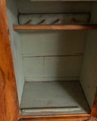 Empty wooden cabinet with a single shelf and hooks.