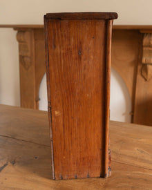 Wooden cabinet on a wooden surface with a blurred background