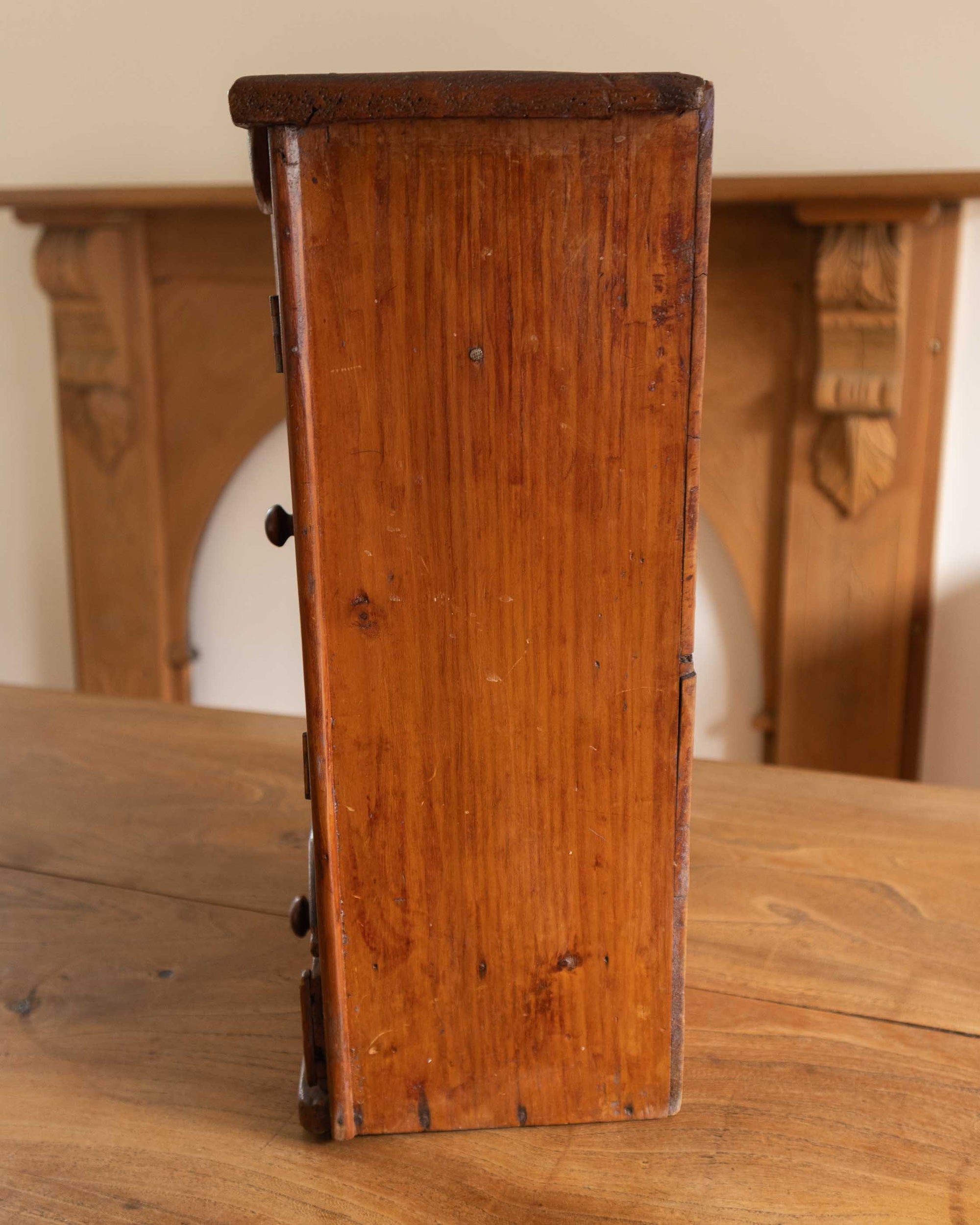 Wooden cabinet on a wooden surface with a blurred background