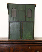 Vintage green wooden cabinet with metal doors on a white background
