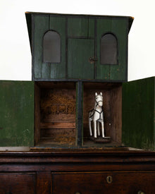 Wooden horse stable with a toy horse inside on a white background