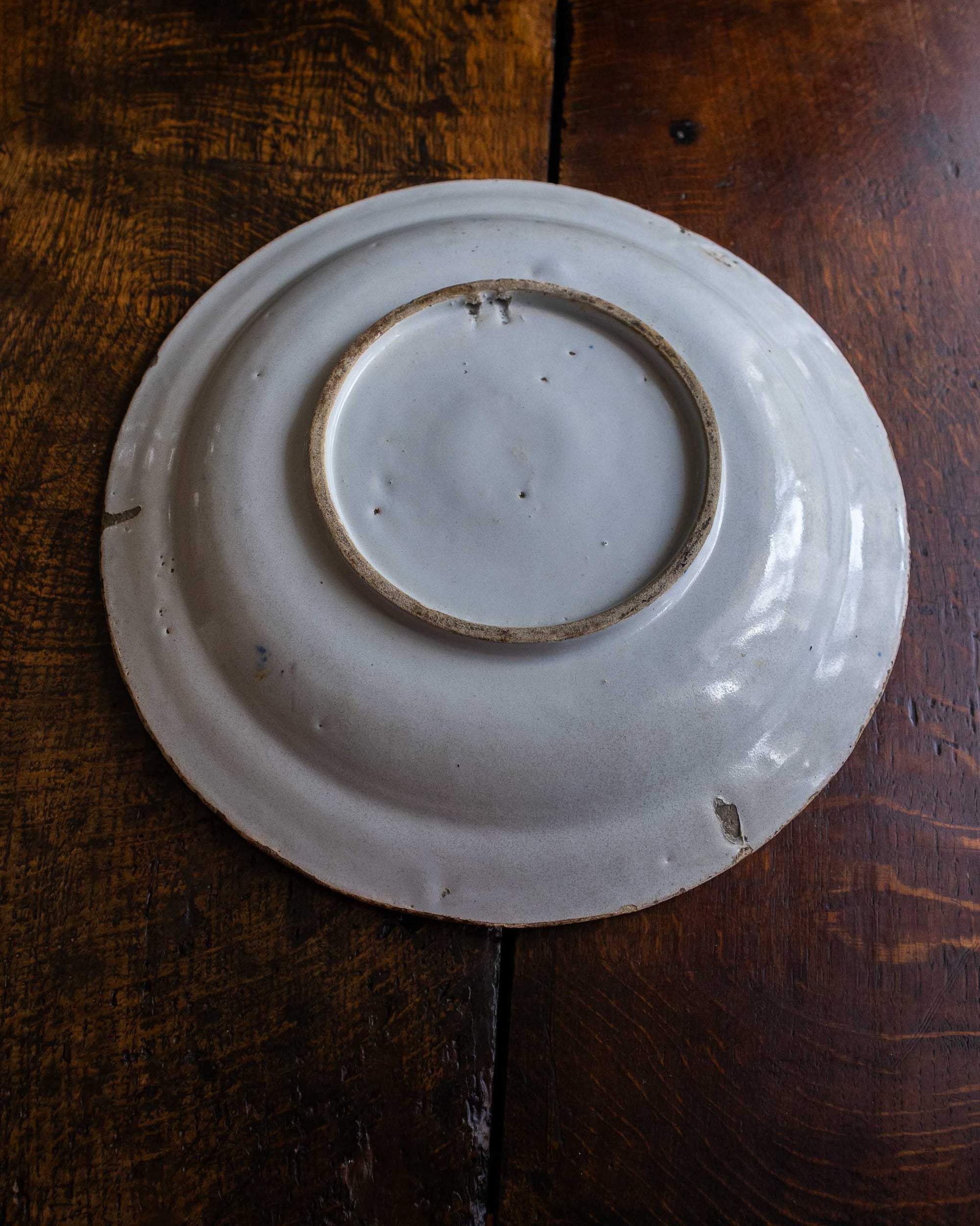White ceramic plate with brown rim on a wooden surface
