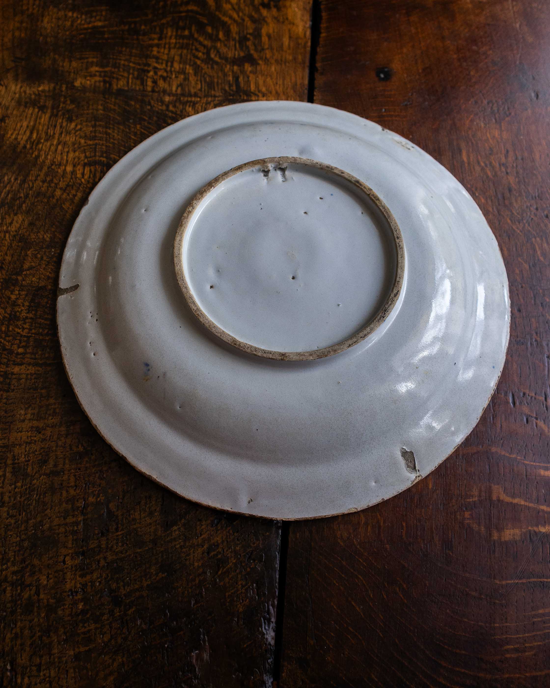 White ceramic plate with brown rim on a wooden surface