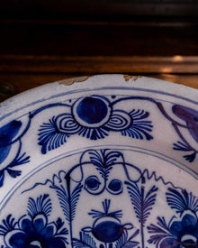 Close-up of a ceramic plate with blue floral patterns on a wooden surface