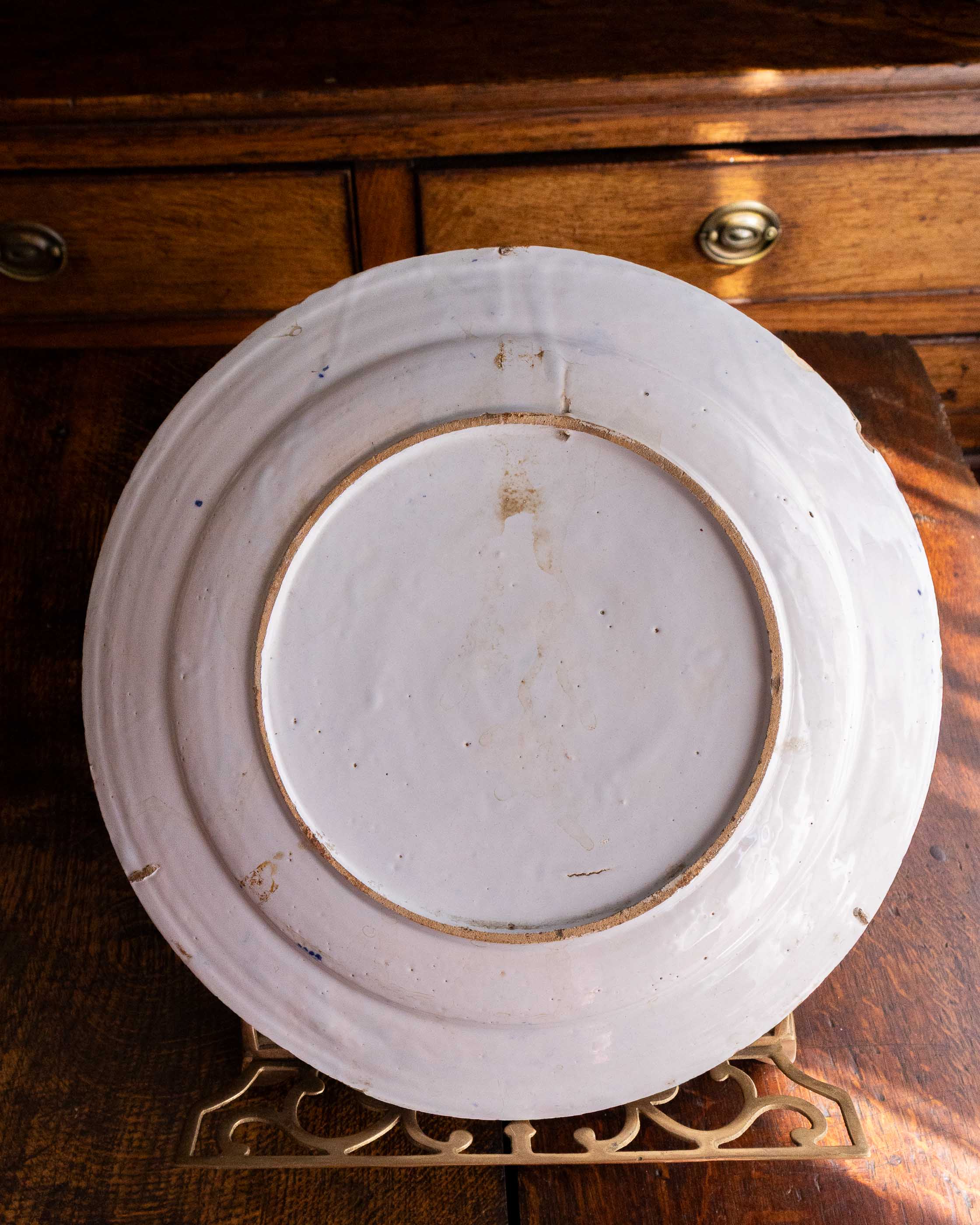 White ceramic plate with rim on a wooden surface