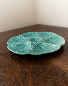 Turquoise ceramic plate with textured design on a wooden surface