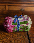 Small decorative box with pink floral pattern on a wooden surface