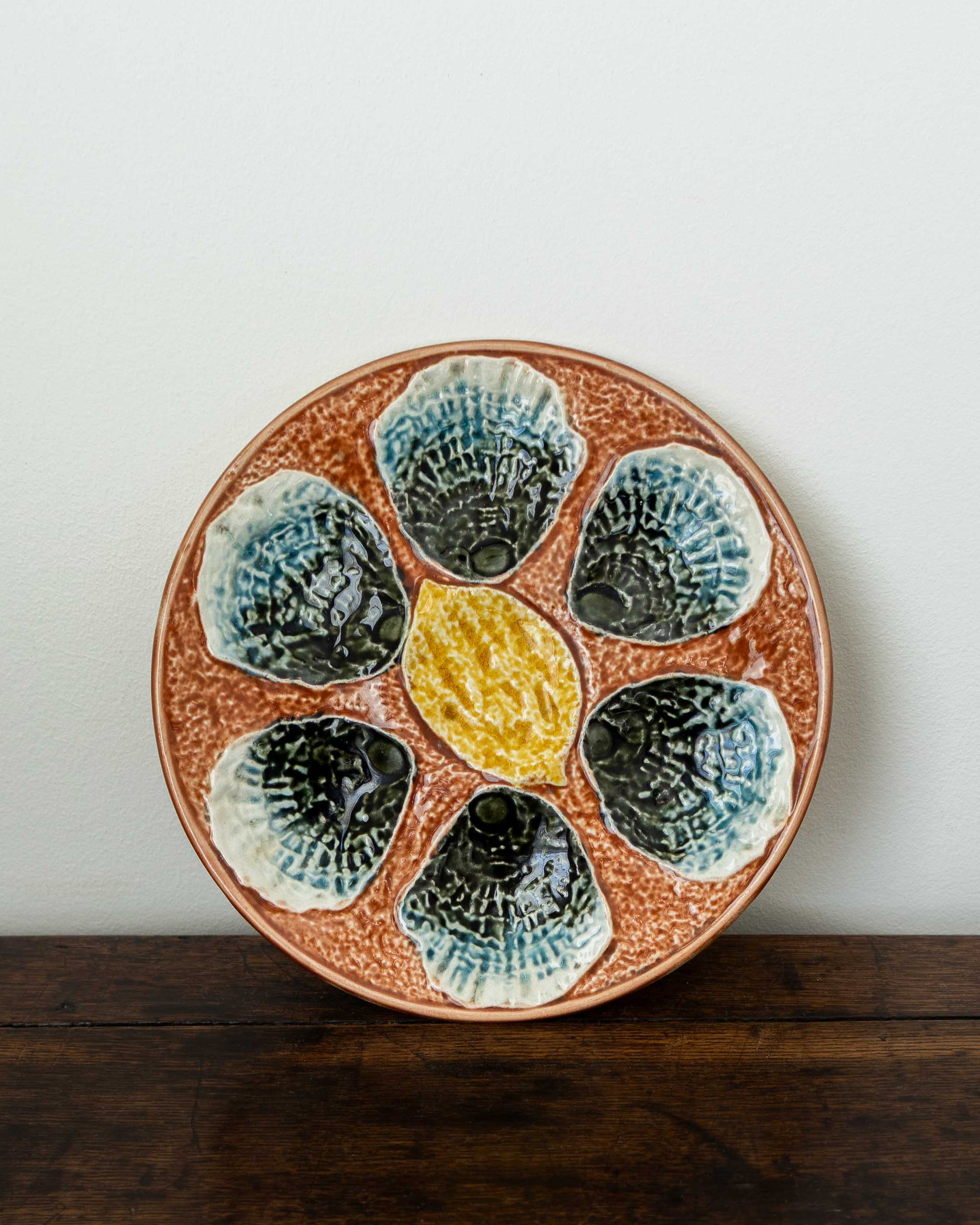 Ceramic plate with shell design on a wooden surface