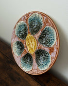 Ceramic plate with shell design on a wooden surface