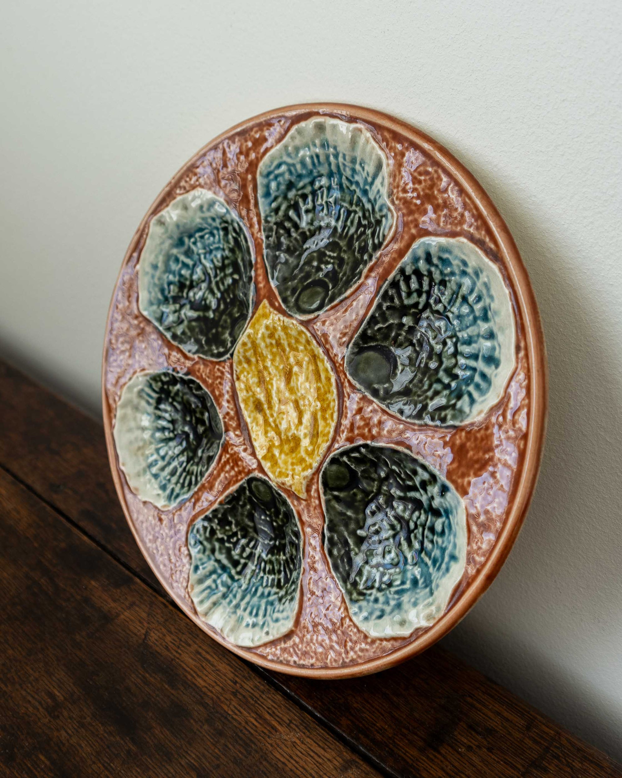 Ceramic plate with shell design on a wooden surface