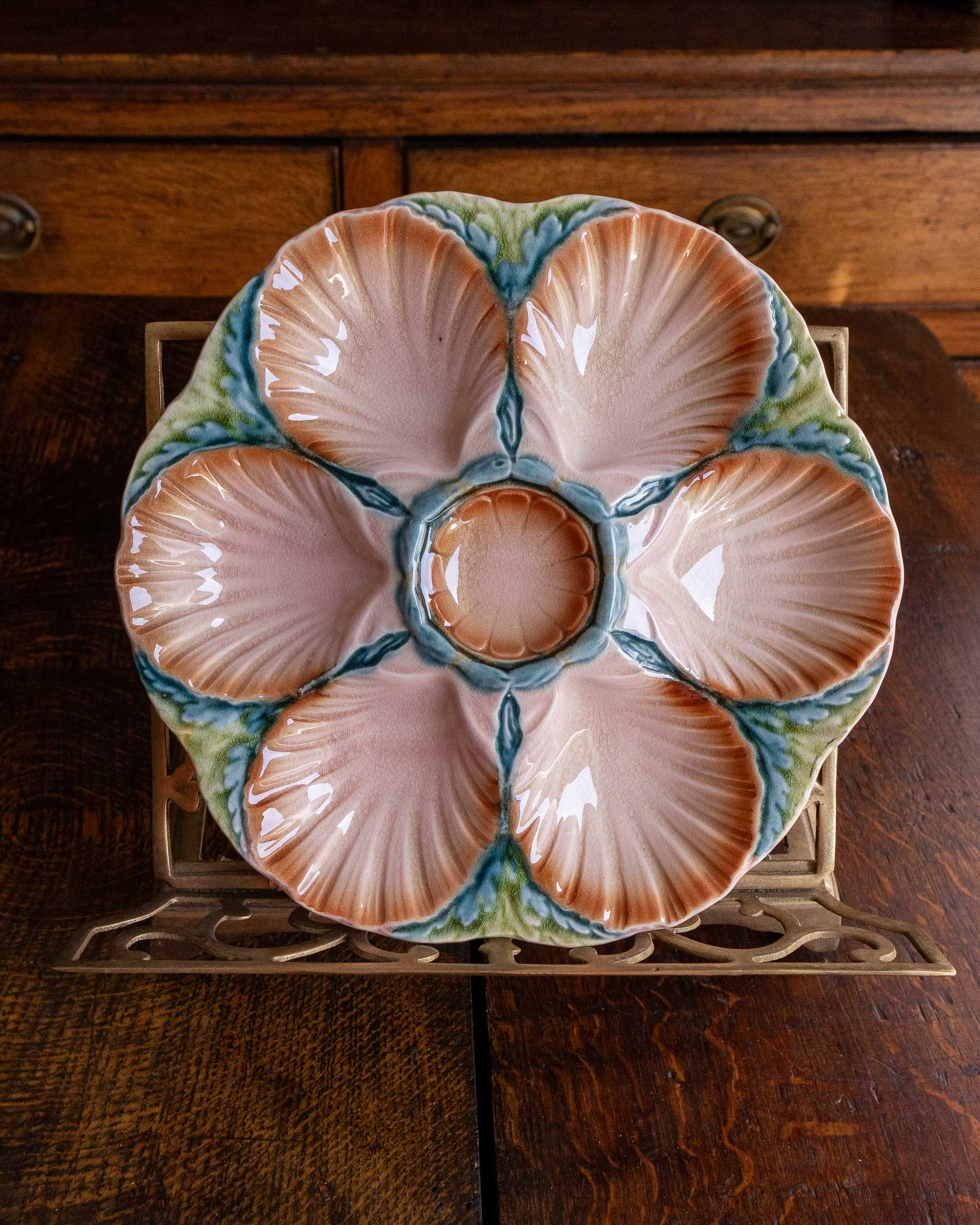 Ceramic oyster plate with shell design on a wooden surface