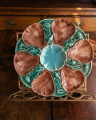 Decorative ceramic oyster plate with shell design on a wooden surface