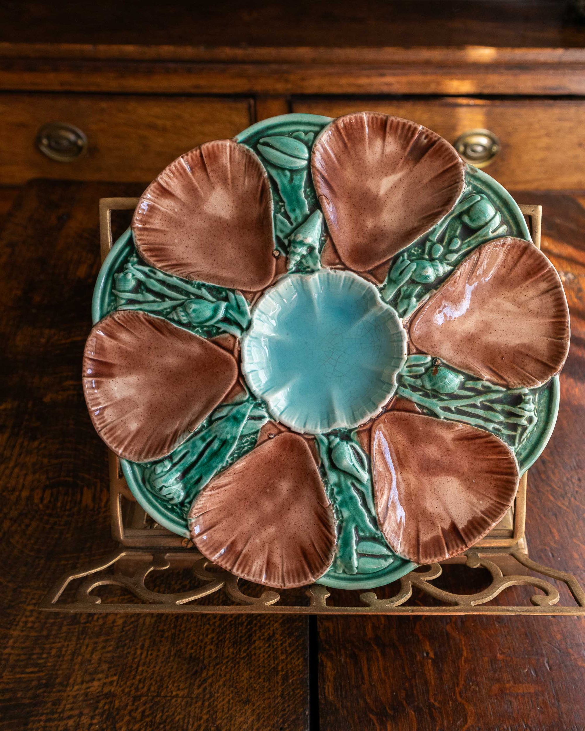Decorative ceramic oyster plate with shell design on a wooden surface