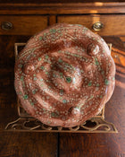 Decorative ceramic plate with a swirling pattern on a wooden surface