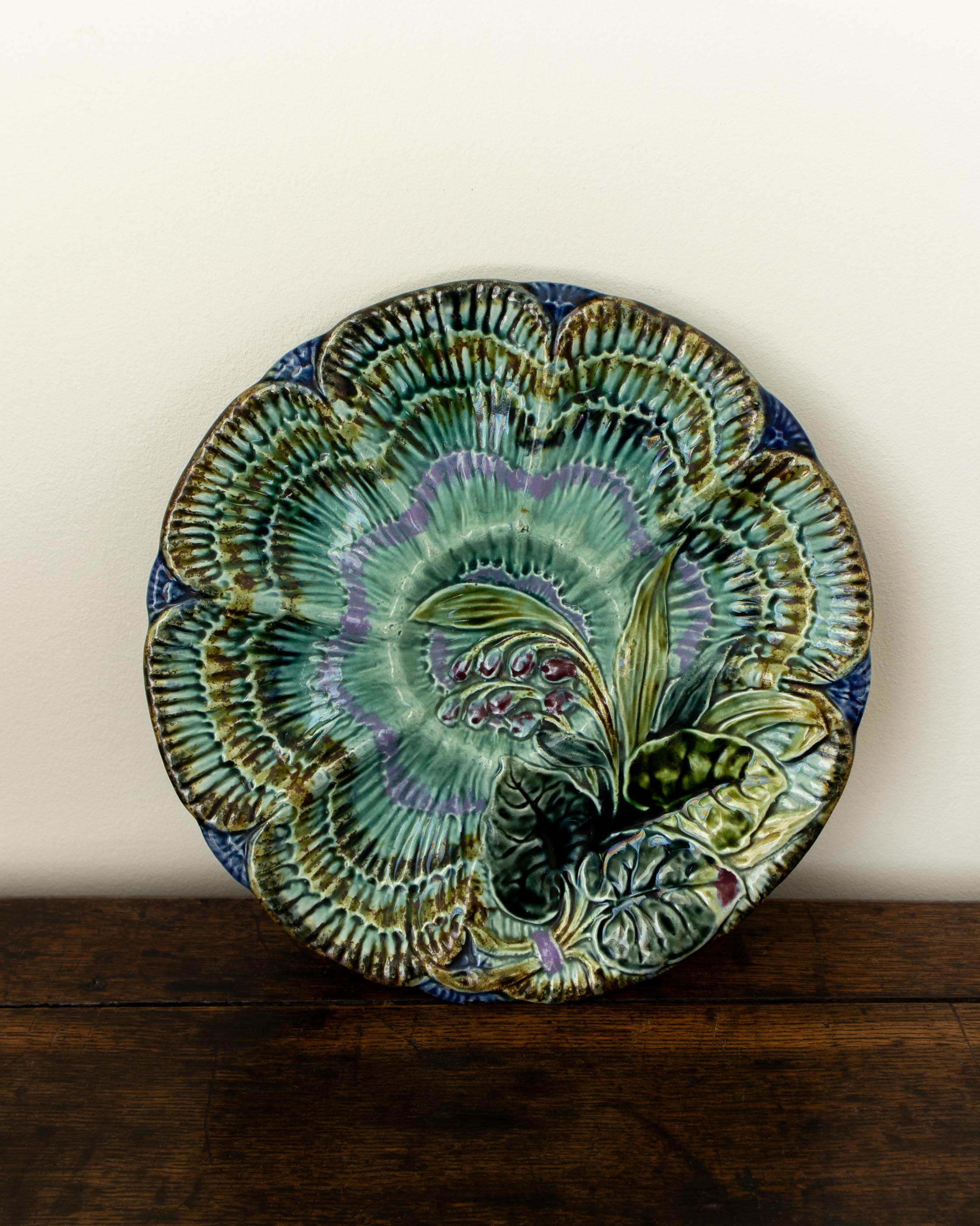 Decorative ceramic plate with floral design on a wooden surface
