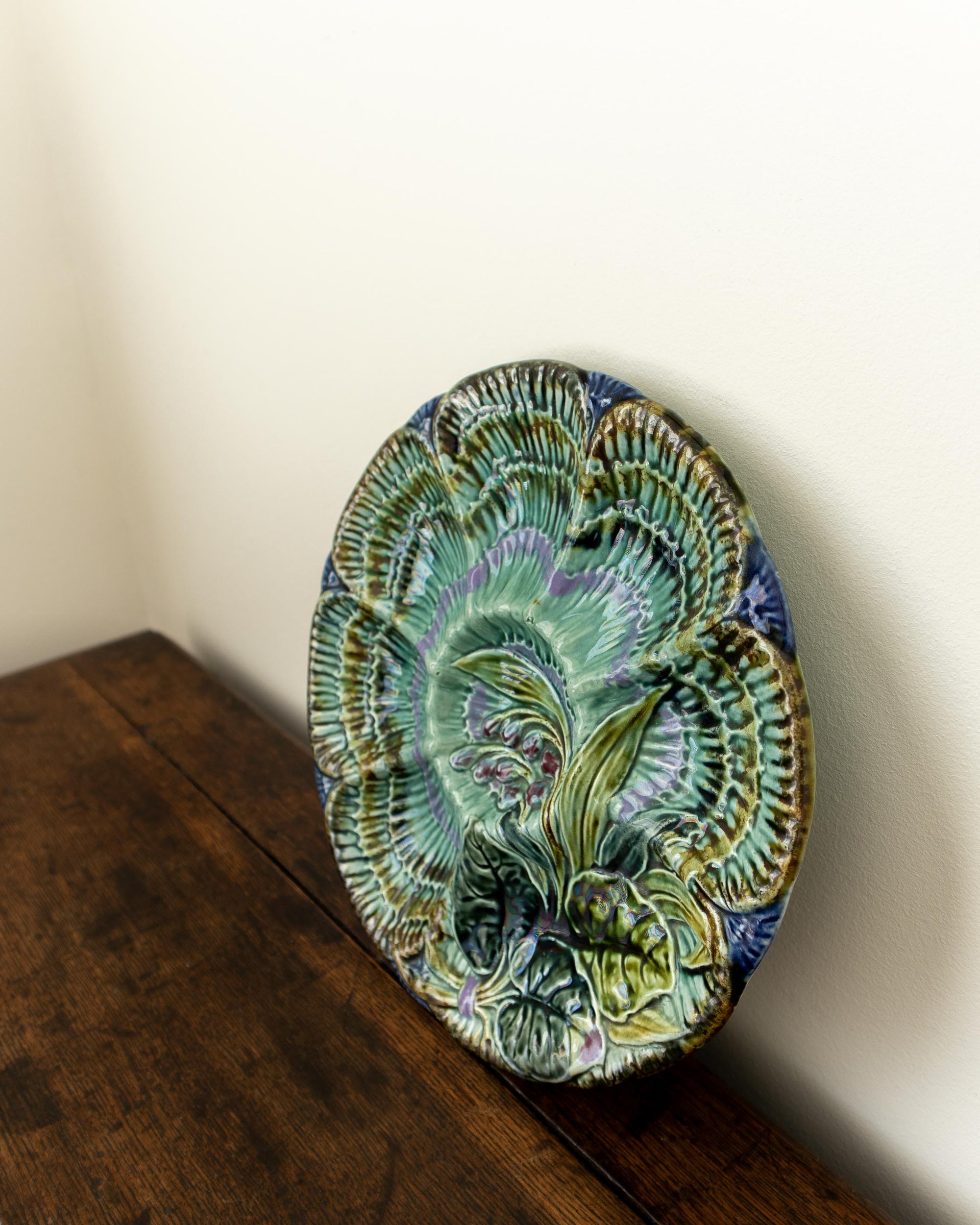 Decorative ceramic plate with floral design on a wooden surface