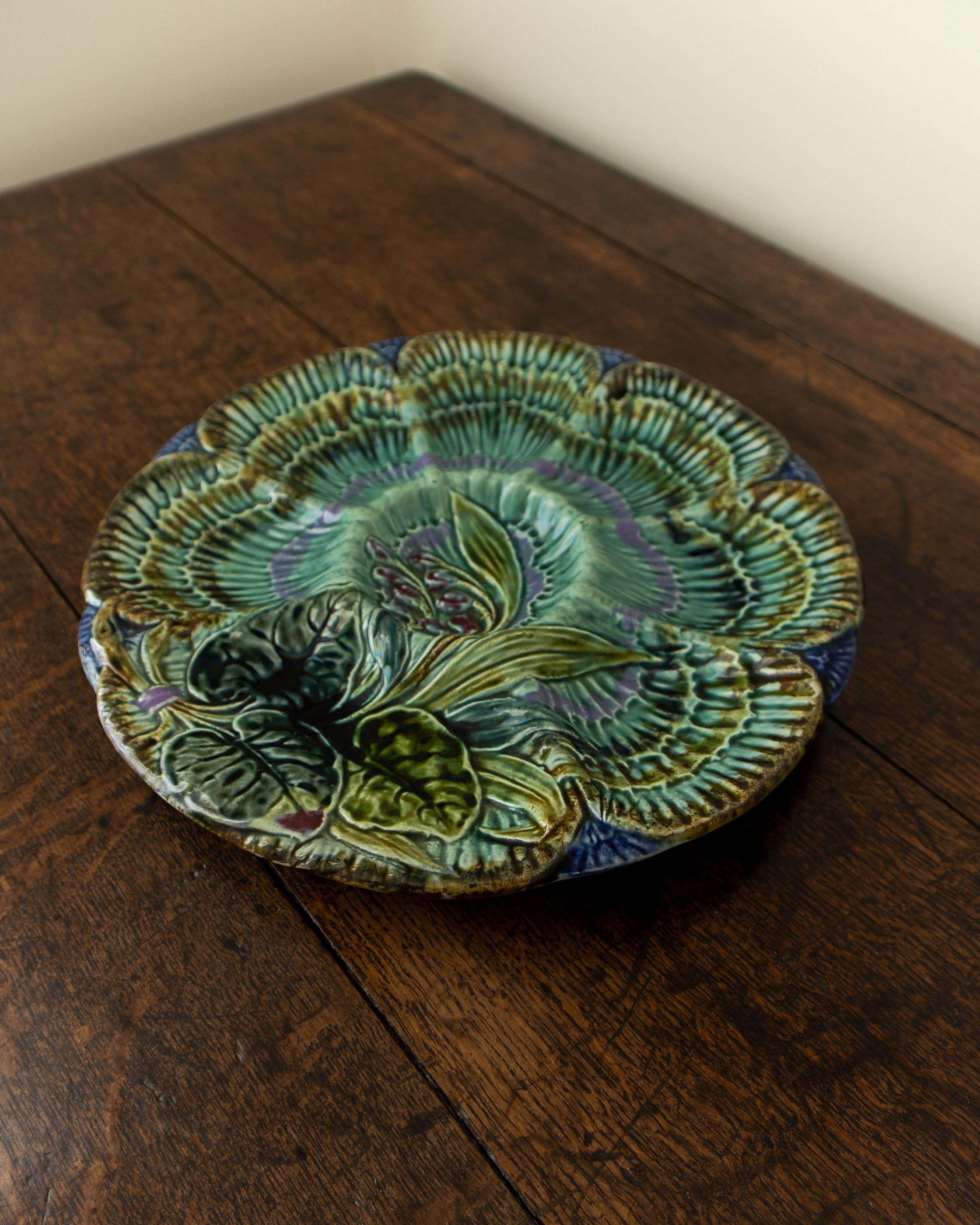 Decorative ceramic plate with floral design on a wooden surface