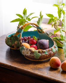 Decorative majolica dish with fruits on a wooden surface