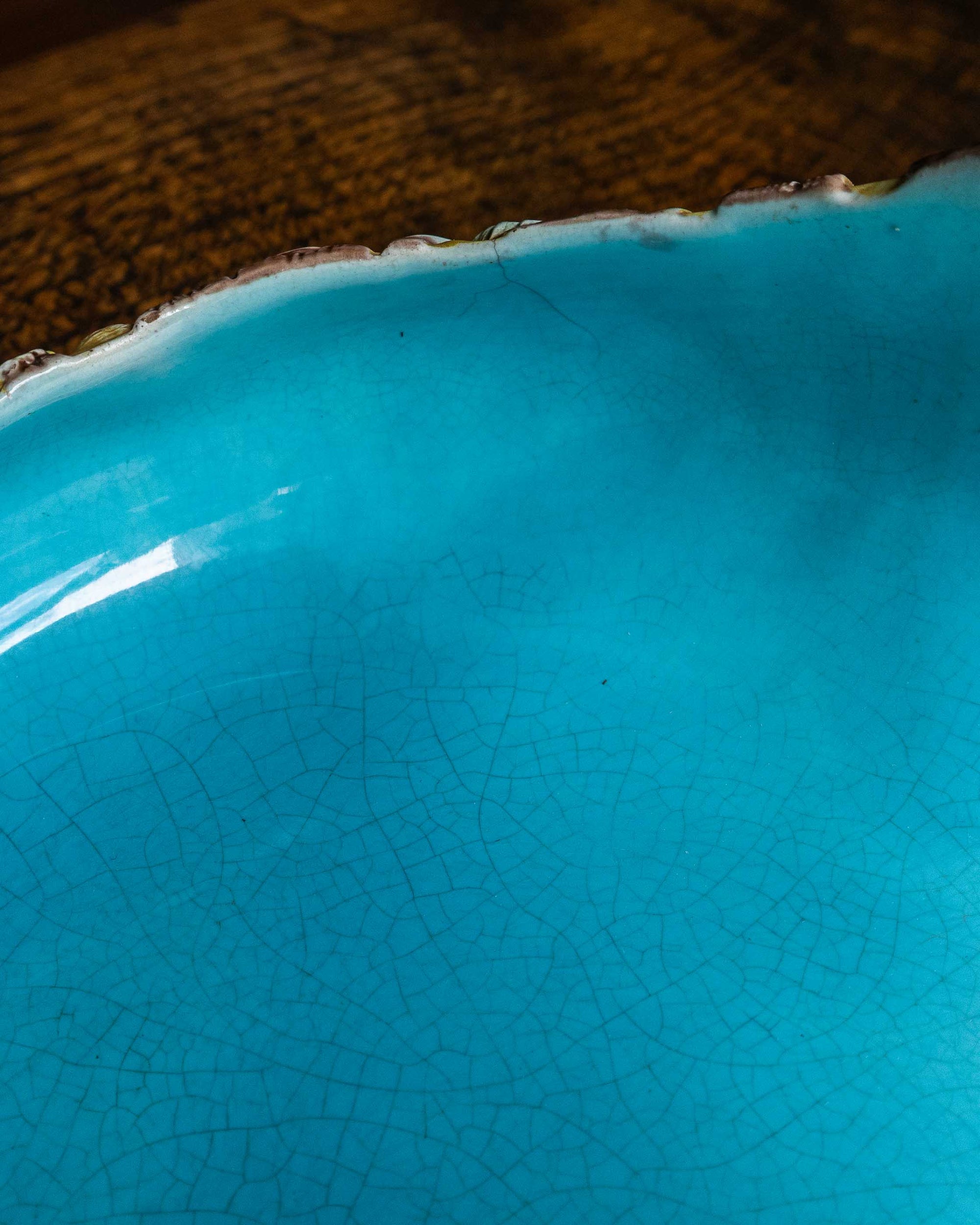 Close-up of a turquoise ceramic bowl with a textured surface.