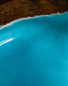 Close-up of a turquoise ceramic bowl with a textured surface.