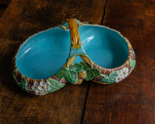 Decorative ceramic basket with floral design on a wooden surface