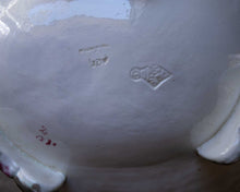 Close-up of a ceramic dish with visible branding and text.