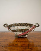 Ceramic woven basket with floral design on a wooden surface