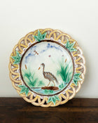 Decorative plate with a bird design on a wooden surface