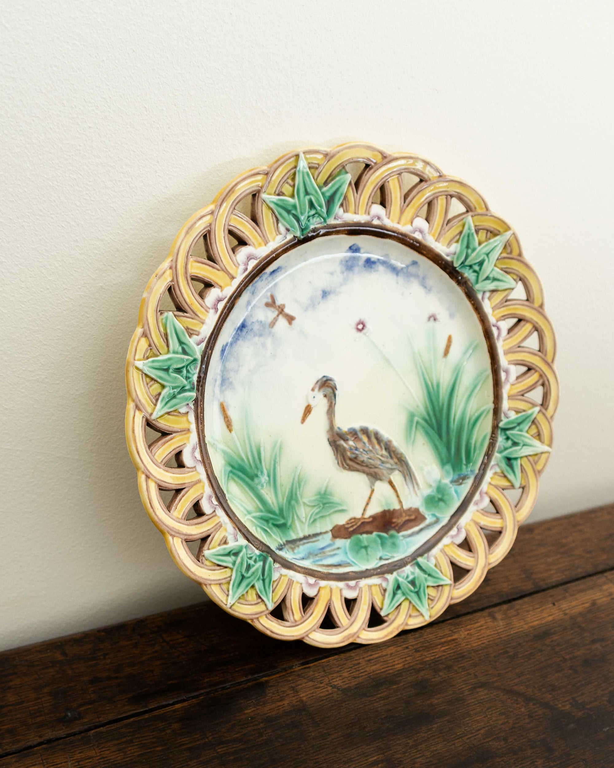 Decorative plate with a bird design on a wooden surface