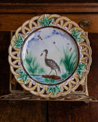 Decorative plate with a bird design on a wooden surface