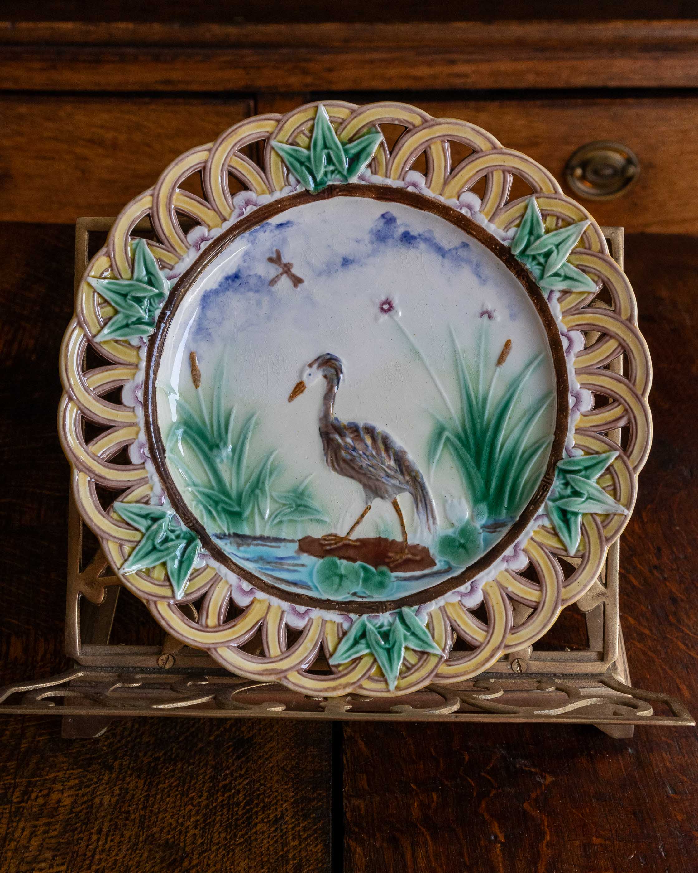 Decorative plate with a bird design on a wooden surface