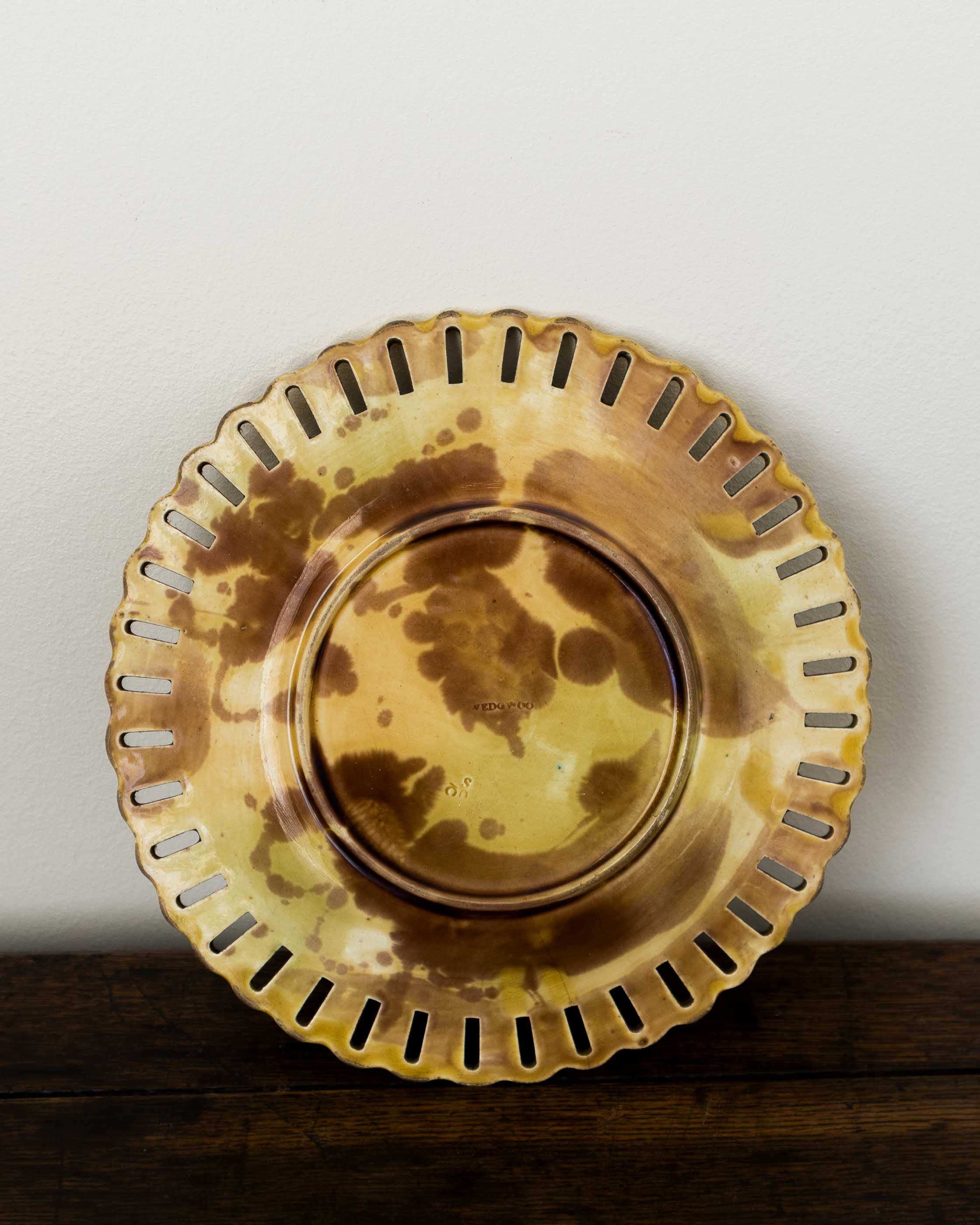 Decorative yellow plate with textured edge on a wooden surface