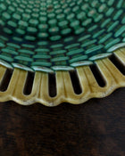 Close-up of a textured green and yellow ceramic dish