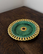 Green and yellow woven plate on a wooden surface