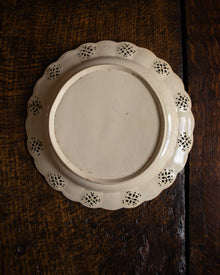 Decorative ceramic plate with intricate patterns on a wooden surface