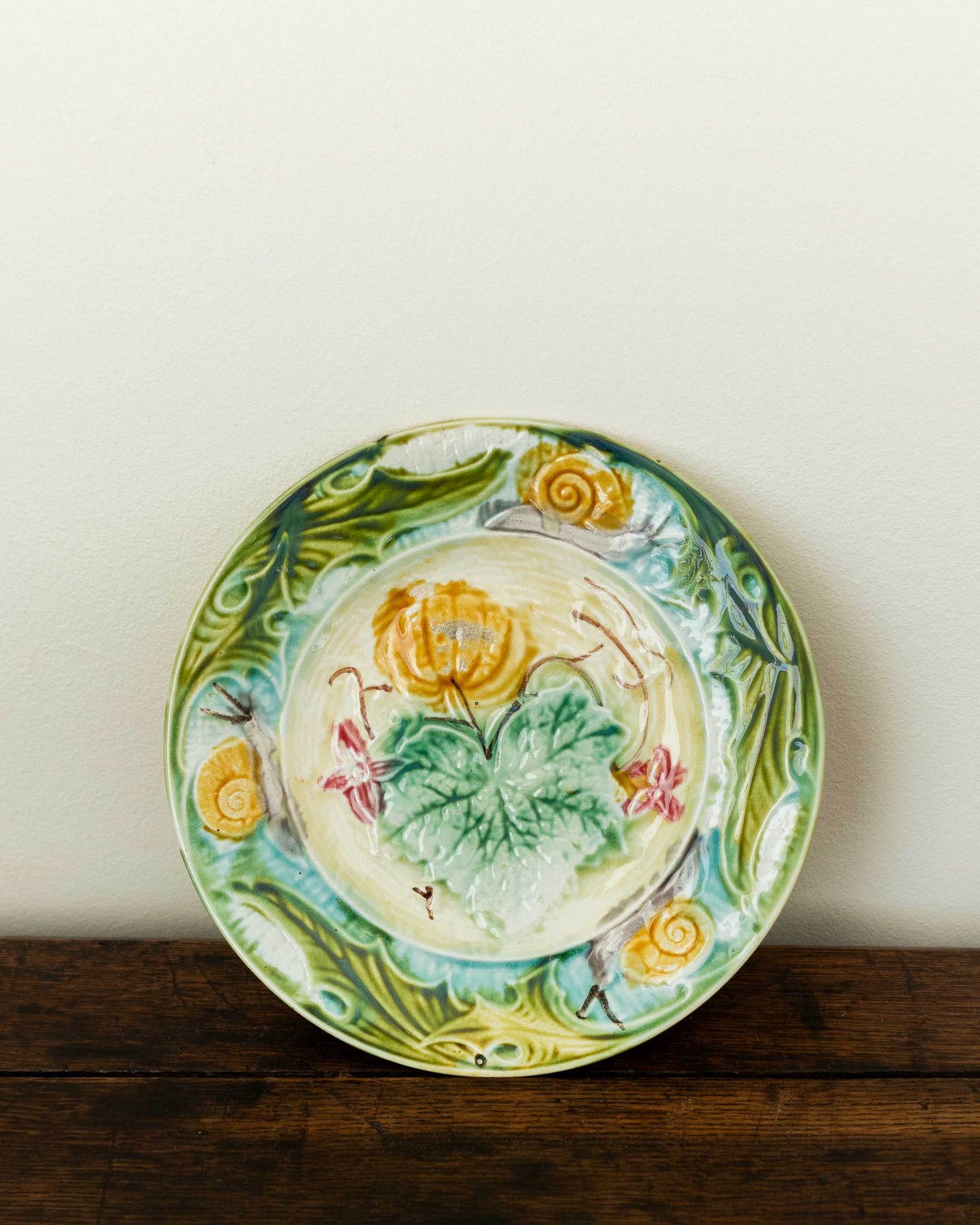 Decorative ceramic plate with floral design on a wooden surface