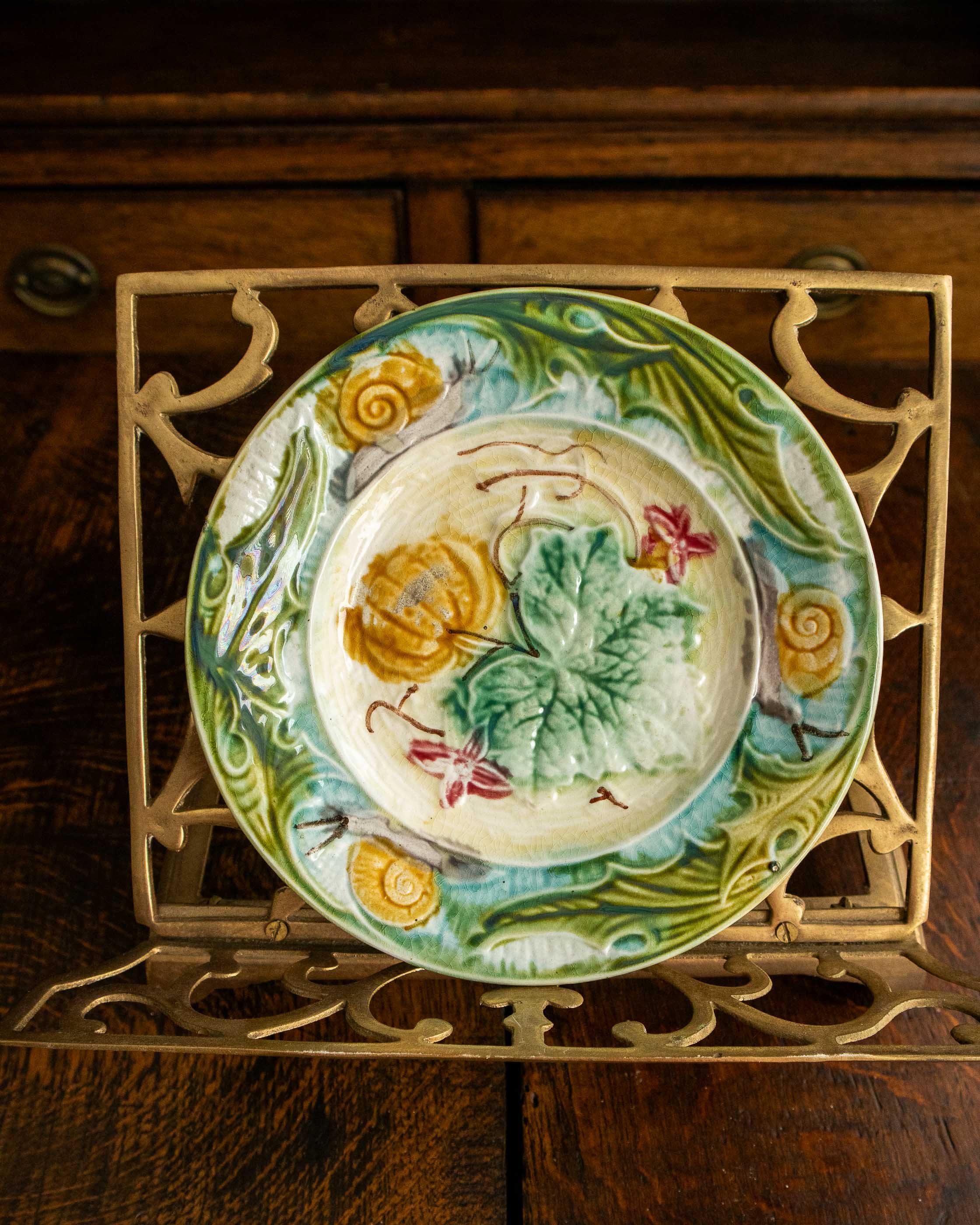 Decorative ceramic plate with floral design on a wooden surface