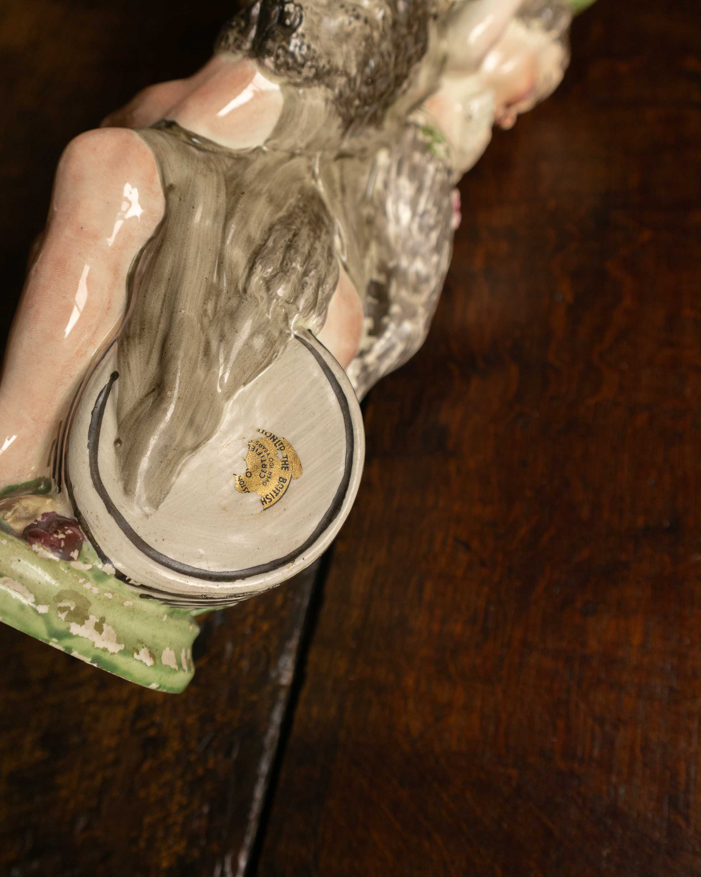 Close-up of a ceramic or porcelain figurine with a detailed design on a dark background