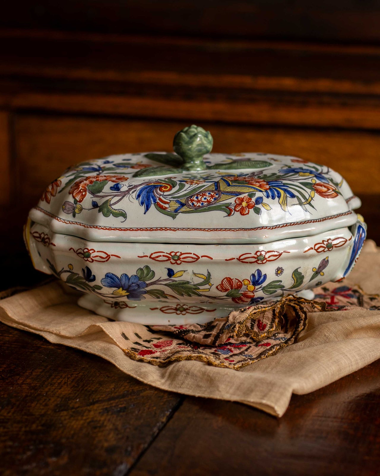 Decorative ceramic dish with floral patterns on a wooden surface