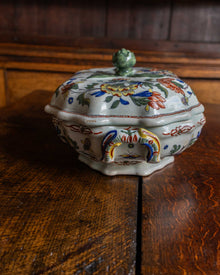 Decorative ceramic tureen on a wooden surface