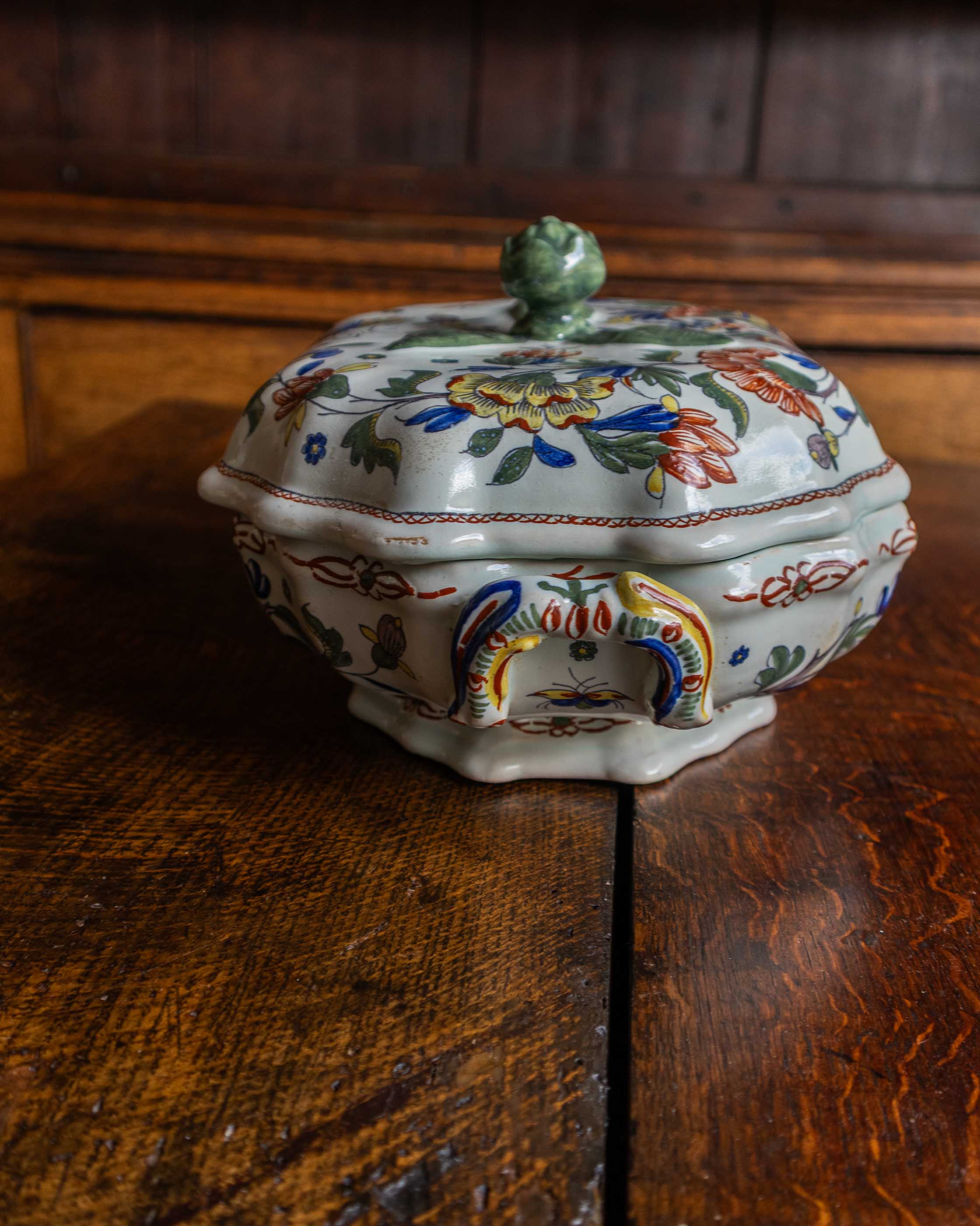 Decorative ceramic tureen on a wooden surface