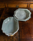 Ceramic tureen and lid on a wooden surface